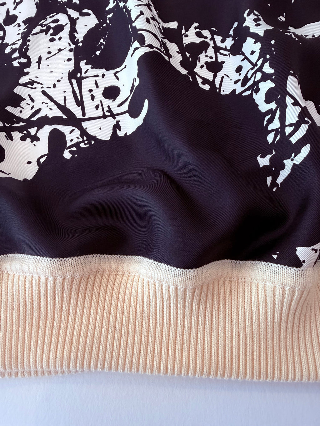 Close up of the virgin wool trim and silk front of Hermes sweater 