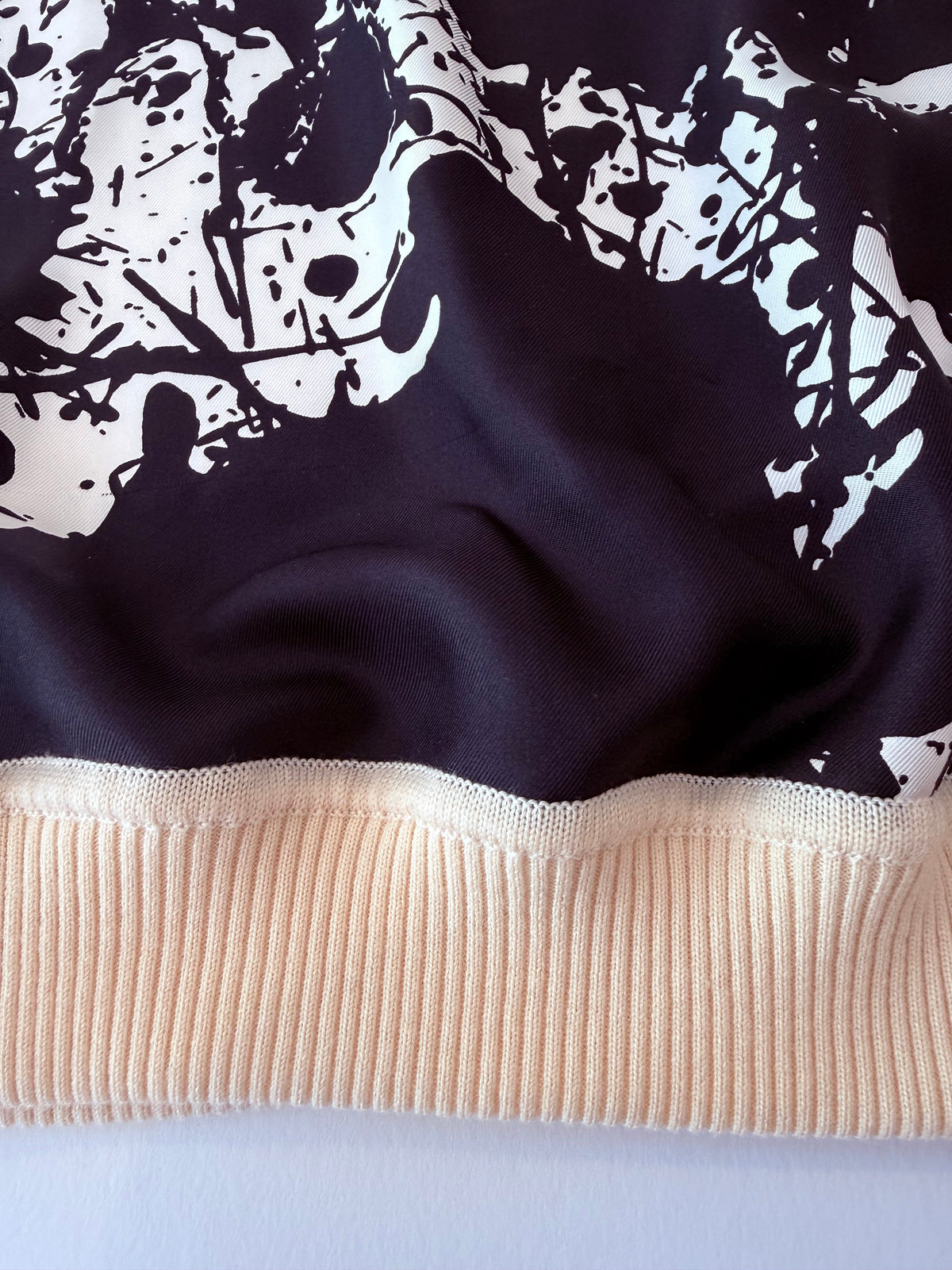 Close up of the virgin wool trim and silk front of Hermes sweater 